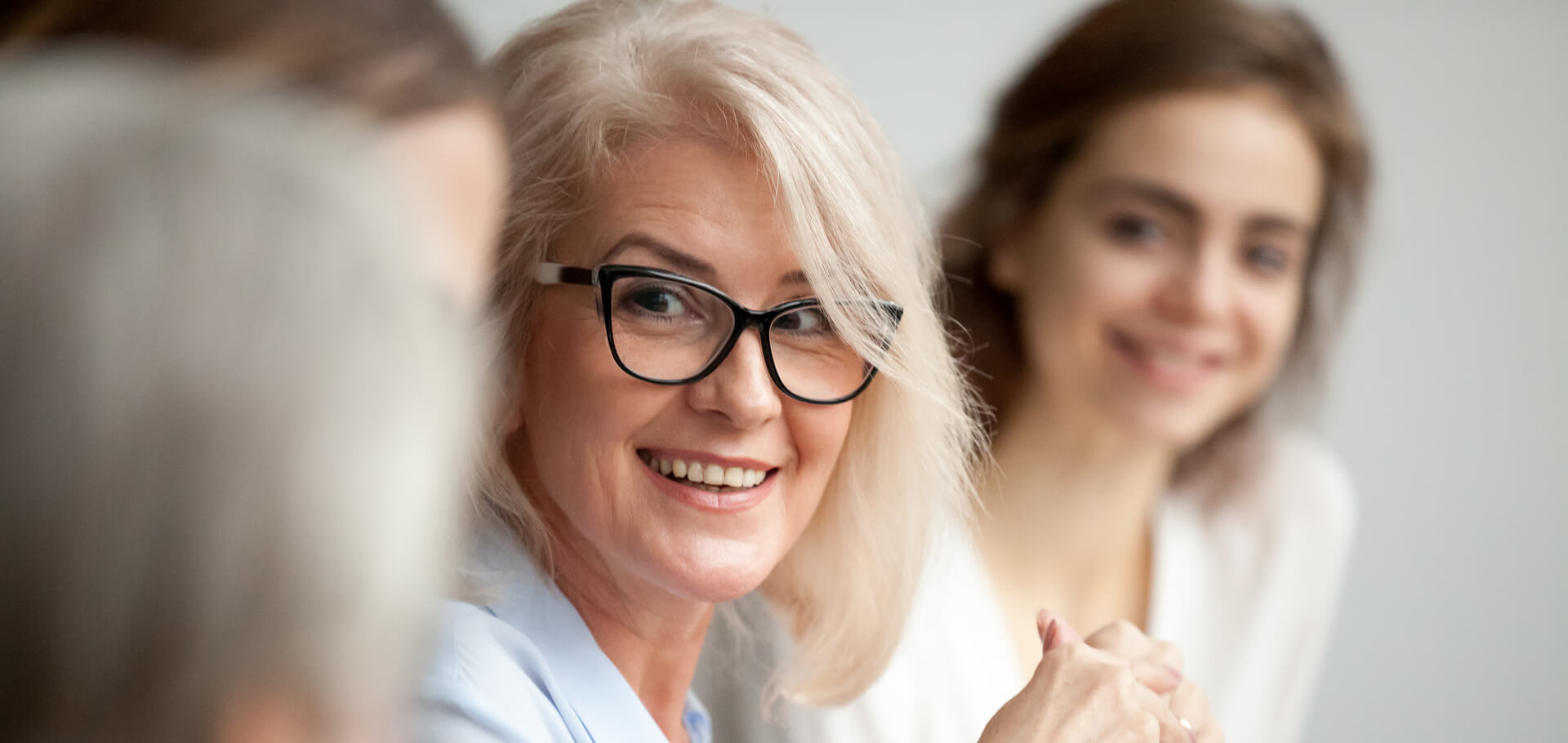 A businesswoman smiling with colleagues.