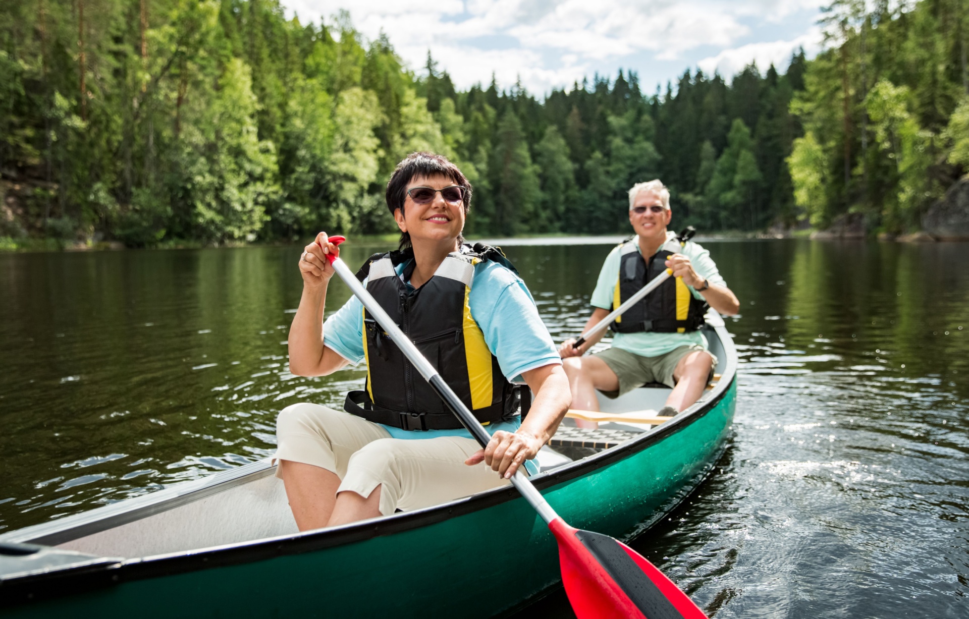 A couple in their 50s canoeing.