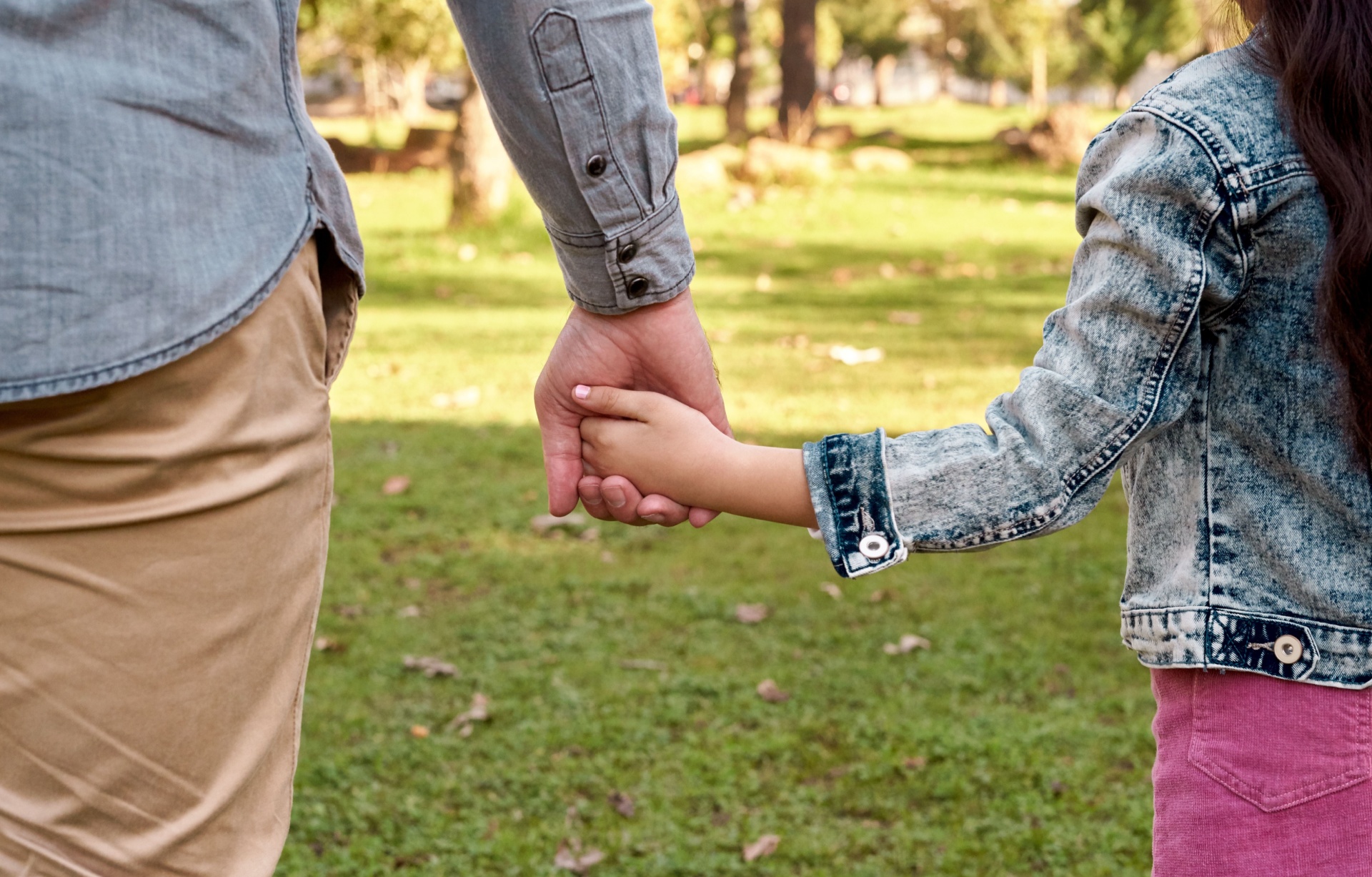 Parent and child holding hands.