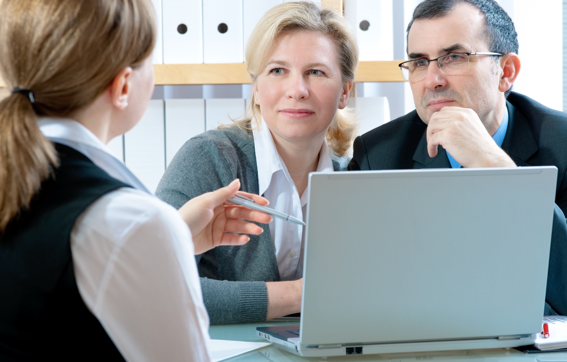 A couple talking to a financial planner.